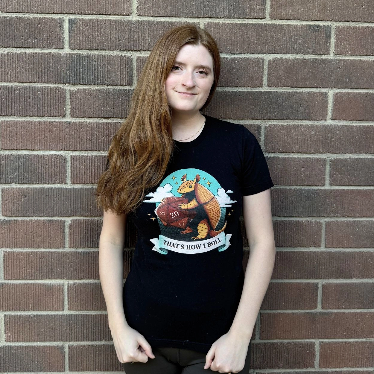 Young woman in a black graphic t-shirt with a dice illustration